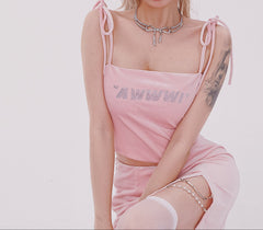 Person wearing a pink outfit with 'MFW' text on a plain background