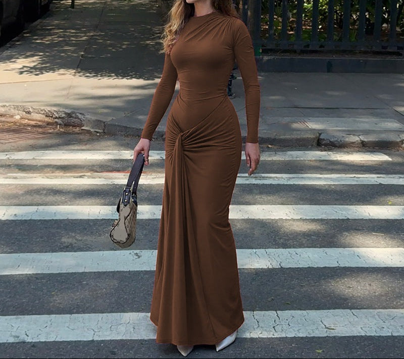 Woman in a brown dress crossing a zebra crossing