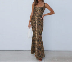Woman wearing a leopard print dress against a white background