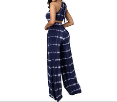 Woman wearing a navy tie-dye two-piece set on a white background