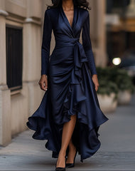 Woman wearing a navy blue dress with ruffled layers on a city street.