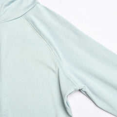 Close-up of a light blue athletic shirt with a white background