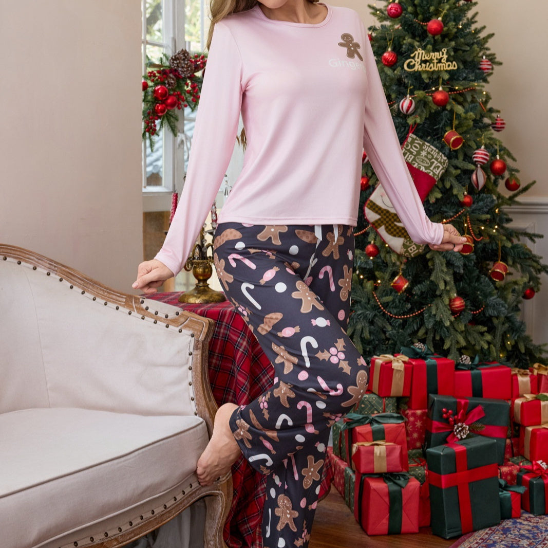 Person wearing festive pajama pants with a Christmas tree and presents in the background