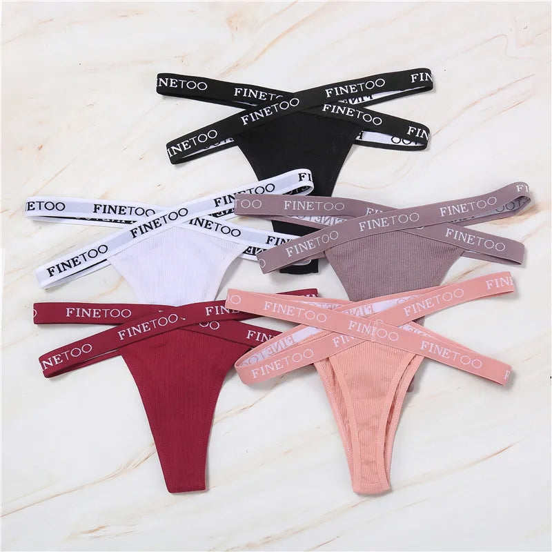 Collection of men's underwear with 'FINETOO' branding on a light wooden surface.