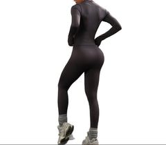 Person wearing a black athletic outfit on a white background