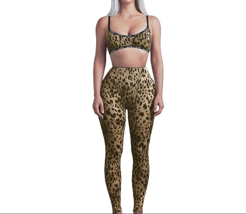 Person wearing a leopard print sports bra and leggings on a white background