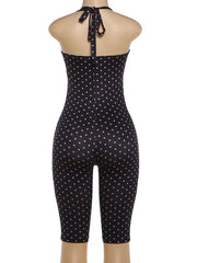 Black polka dot jumpsuit on a mannequin against a white background