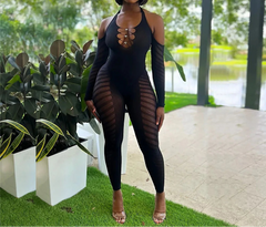 Woman wearing a black outfit with sheer panels in an outdoor setting