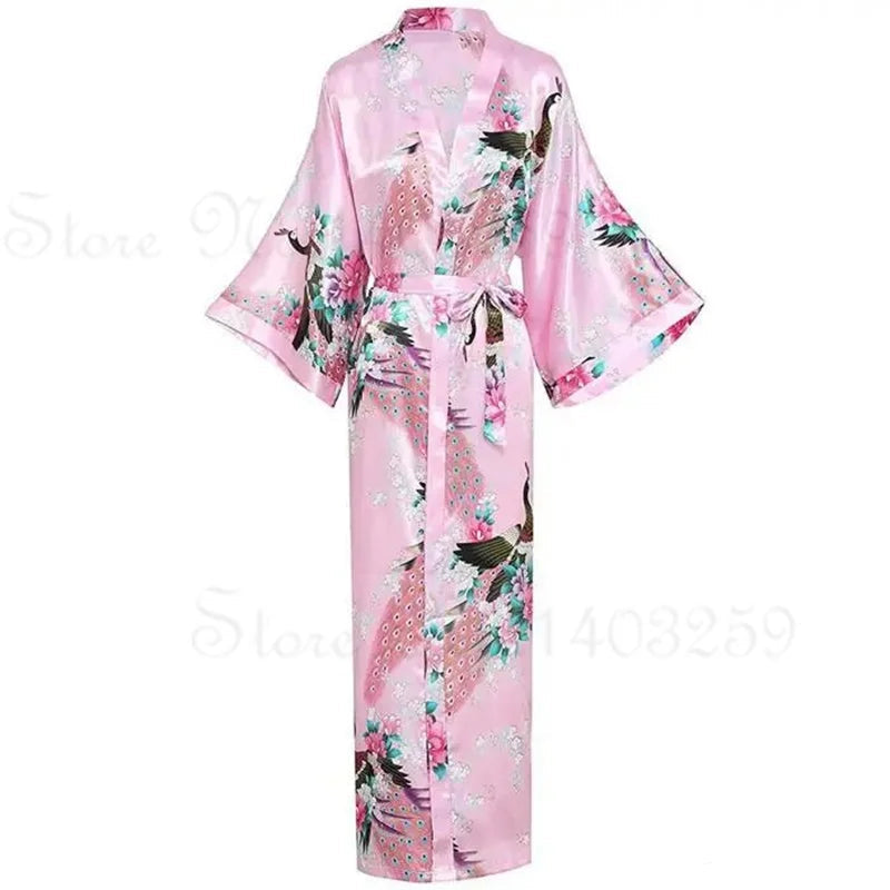 Pink satin robe with floral and bird patterns on a white background