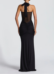 Black evening gown with sheer back on a white background