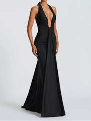 Black evening gown with a plunging neckline on a white background