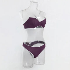 Purple bra and panties set on a clear mannequin against a white background
