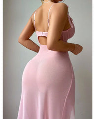Pink evening gown with open back on a plain background