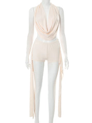 Mannequin wearing a beige draped top and pants on a white background