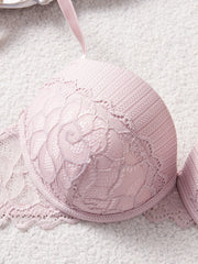 Pink lace bra on a textured surface