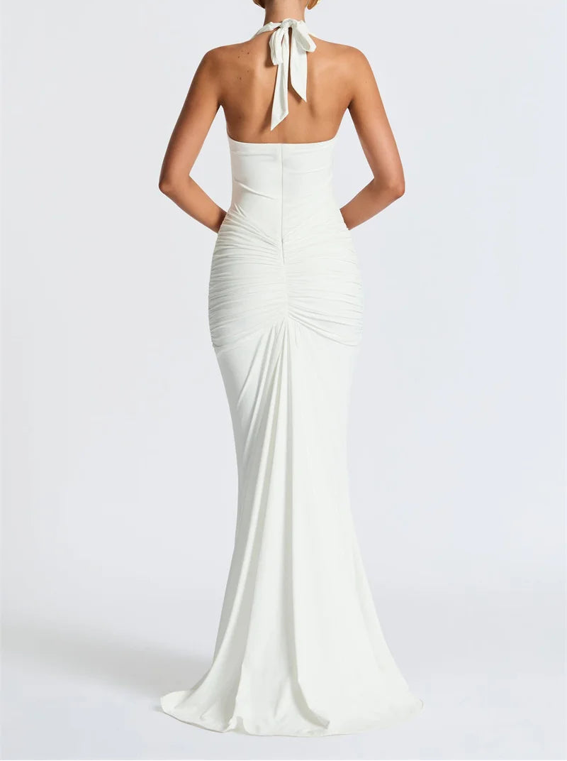 White evening gown with a halter neck design on a white background