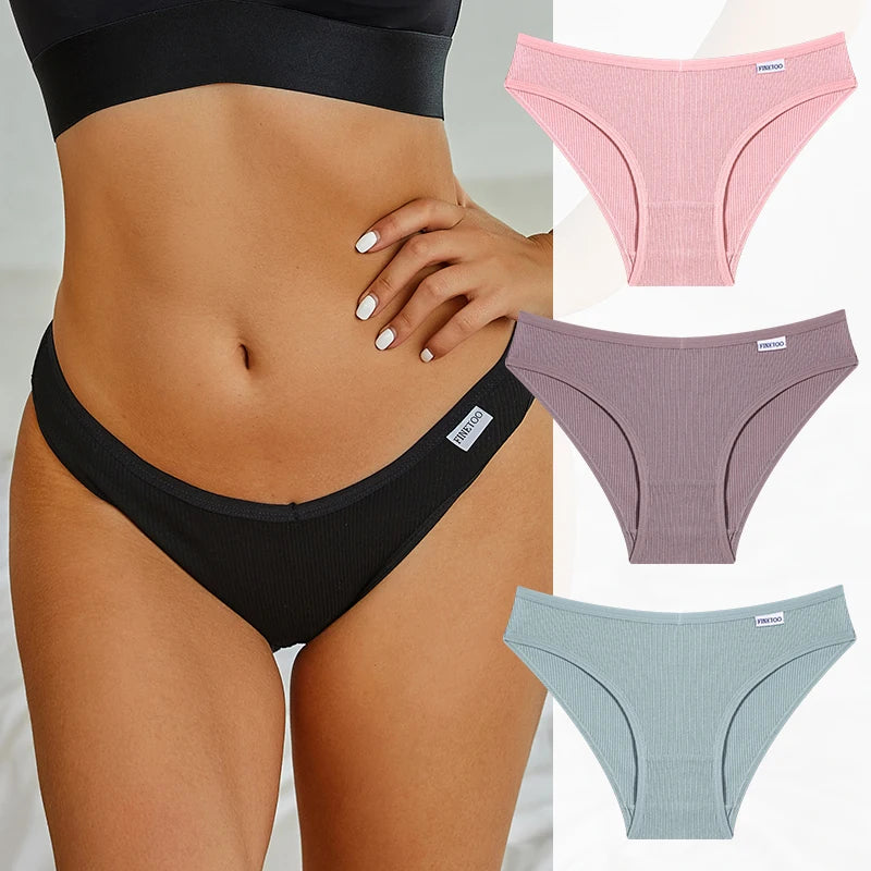 Black underwear worn by a person with additional pink, purple, and light blue underwear displayed.