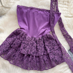 Purple lace dress on a white fur surface