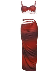Red two-piece dress with a strapless top and draped skirt on a white background
