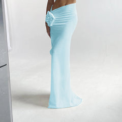 Light blue evening gown with a floral detail on a white background