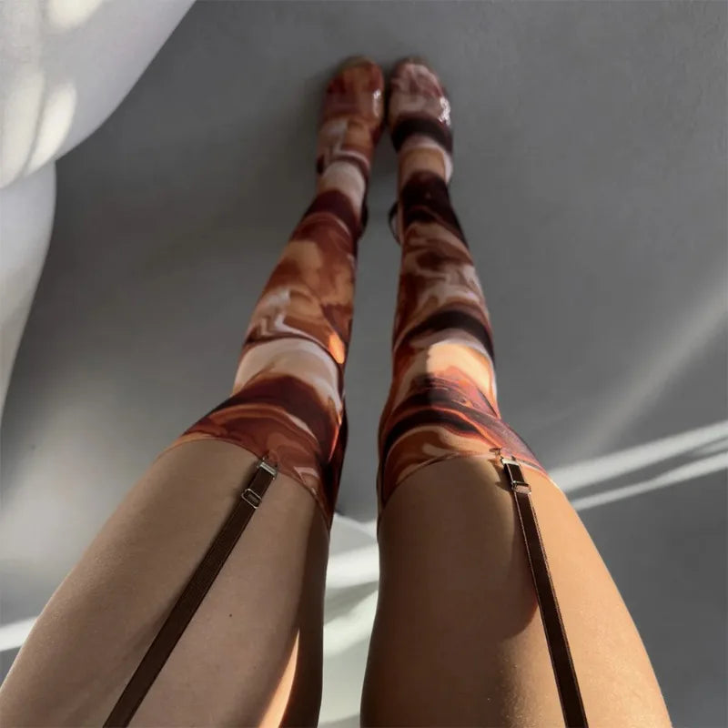 Marbled leggings worn by a person standing on a reflective surface with a gray background