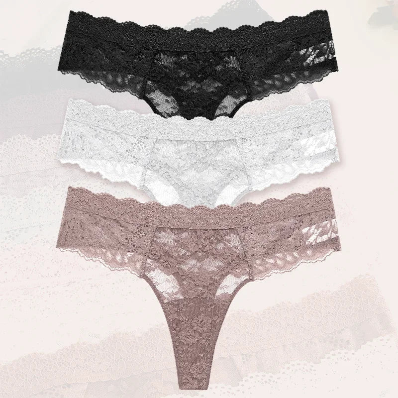 Two pairs of lace-trimmed panties on a textured surface