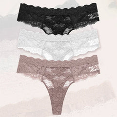 Two pairs of lace-trimmed panties on a textured surface