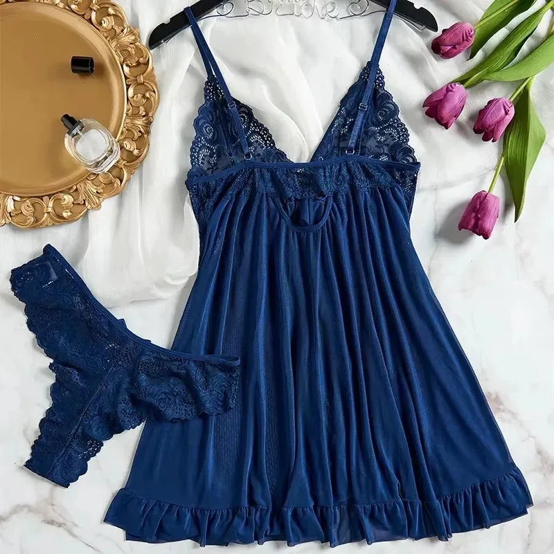 Blue lace nightgown with matching panties on a marble surface with decorative elements.
