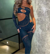 Woman wearing a blue cut-out dress against a textured wall.