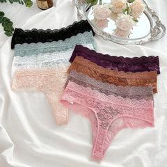 Set of lace-trimmed panties in various colors on a white fabric background.