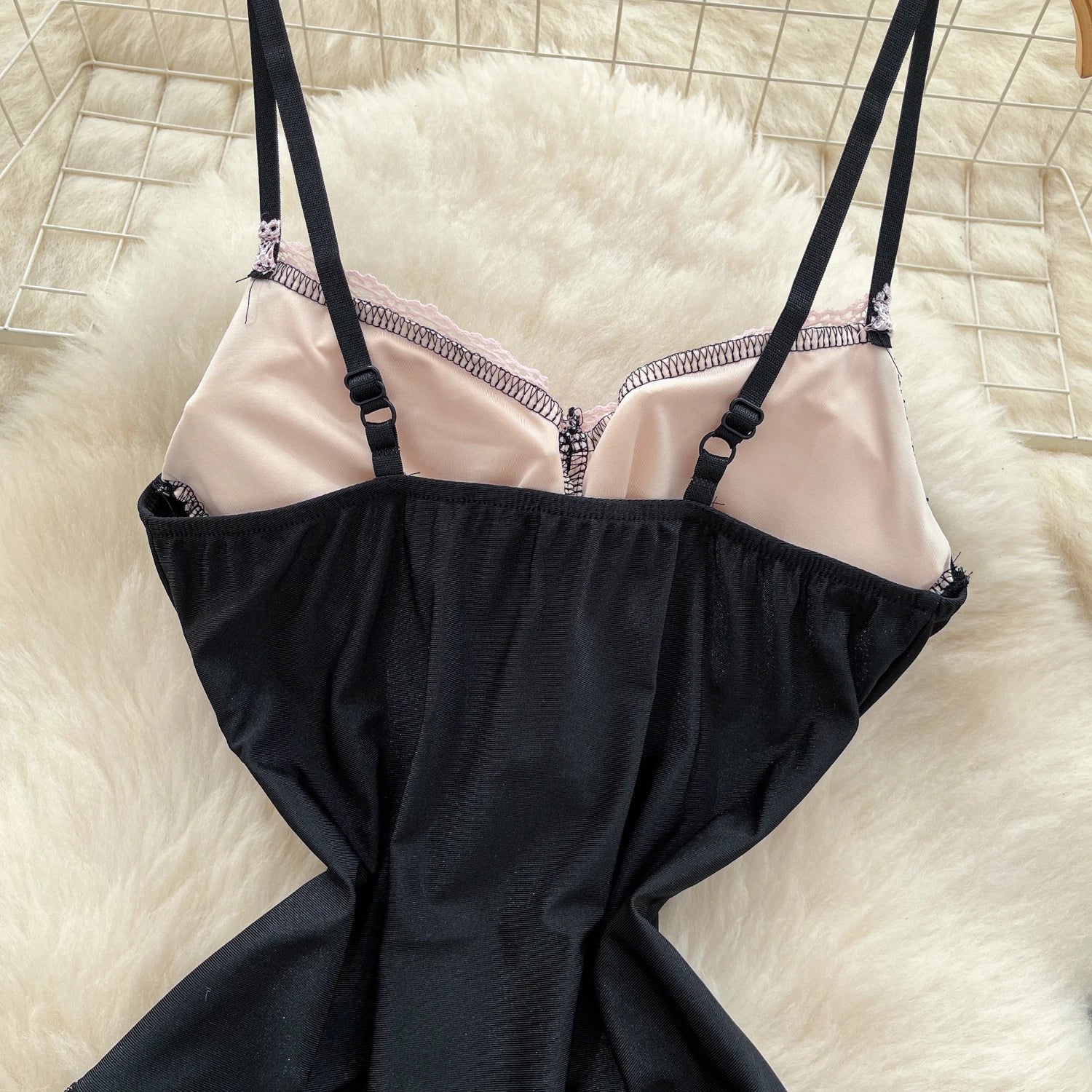 Black and pink lingerie set on a textured surface