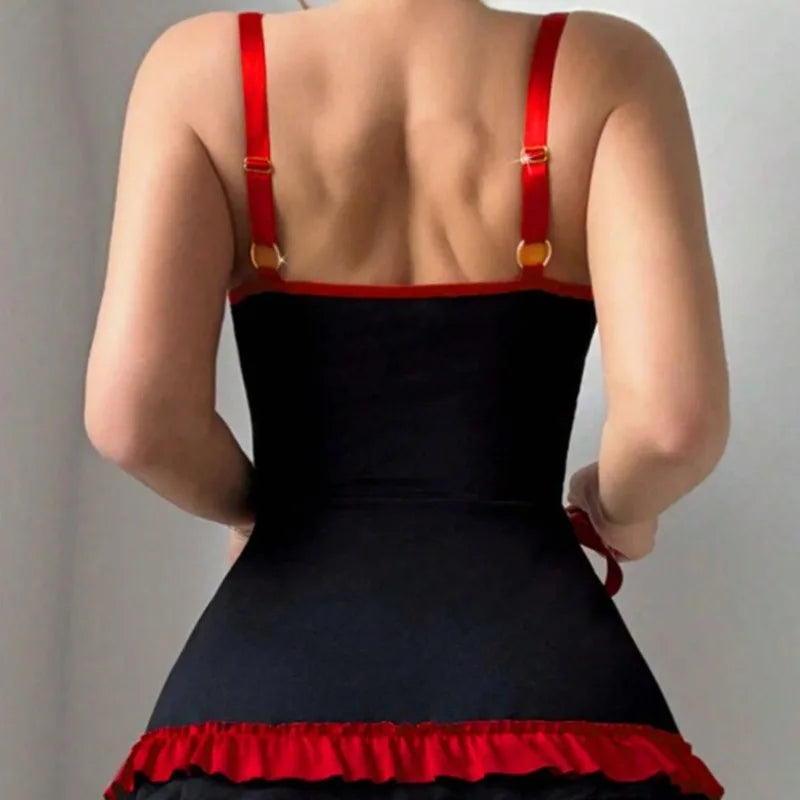 Black dress with red straps and hem on a neutral background