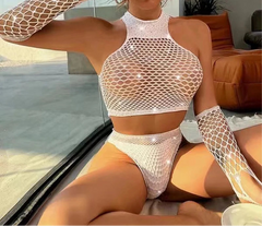Woman in a fishnet top and shorts sitting by a poolside.