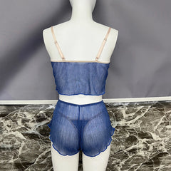 Mannequin wearing a blue sheer outfit against a gray background