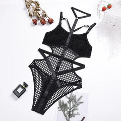 Black fishnet lingerie set on a light background with decorative elements.