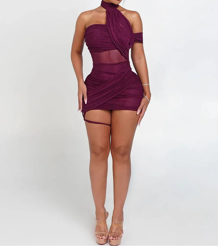 Woman wearing a burgundy dress with sheer panels on a white background