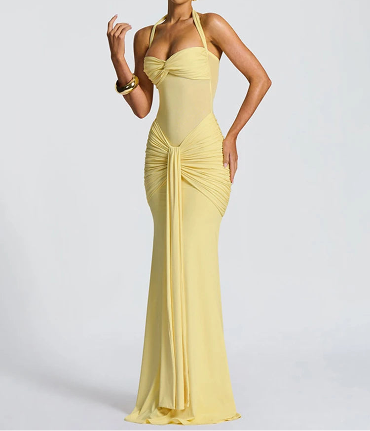 Woman wearing a yellow evening gown against a white background