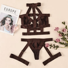 Brown strappy lingerie set on a beige surface with flowers and a magazine.