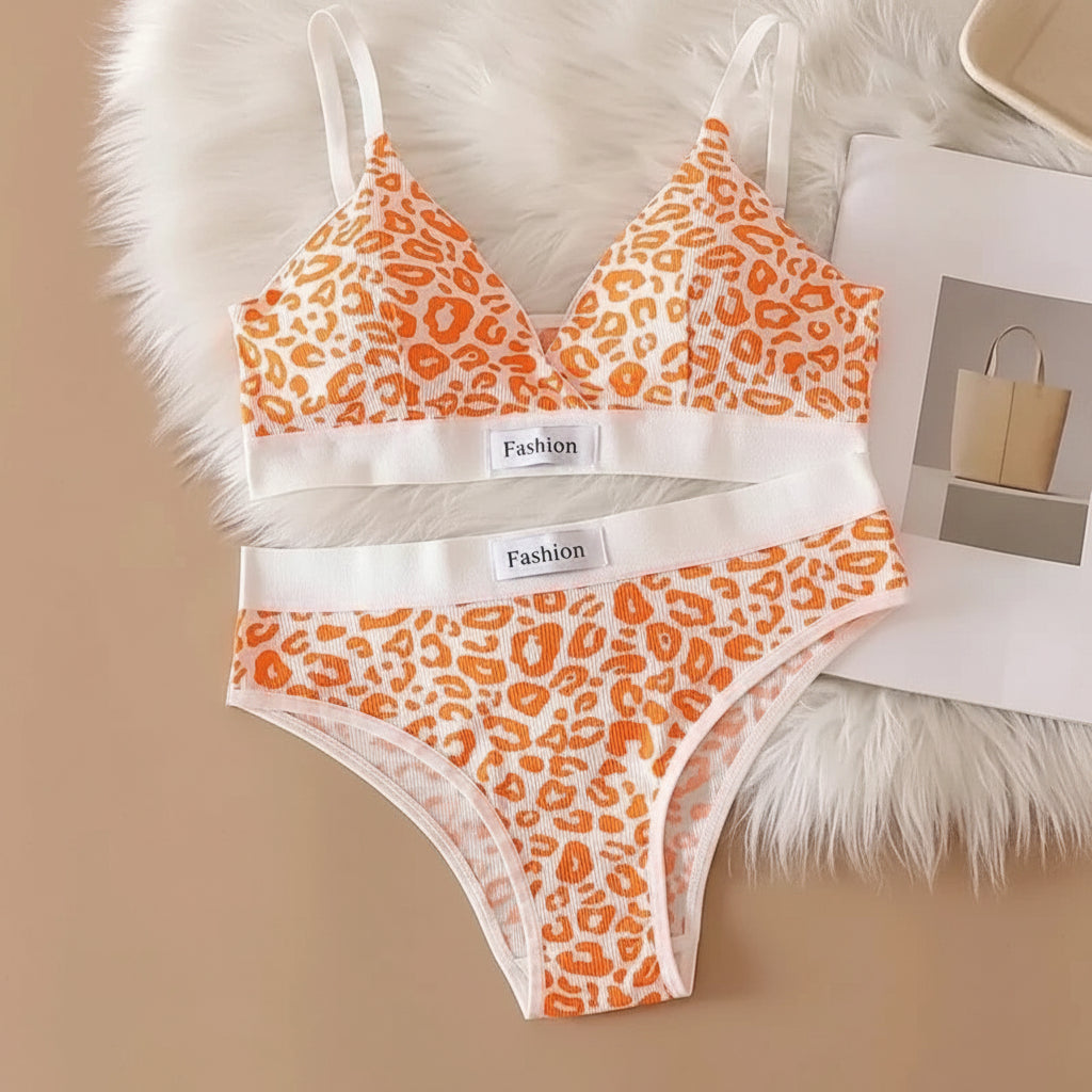 Leopard print bra and panties set on a textured surface with 'Fashion' label.