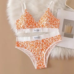 Leopard print bra and panties set on a textured surface with 'Fashion' label.