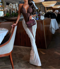 Woman in a stylish dress standing in an elegant restaurant setting