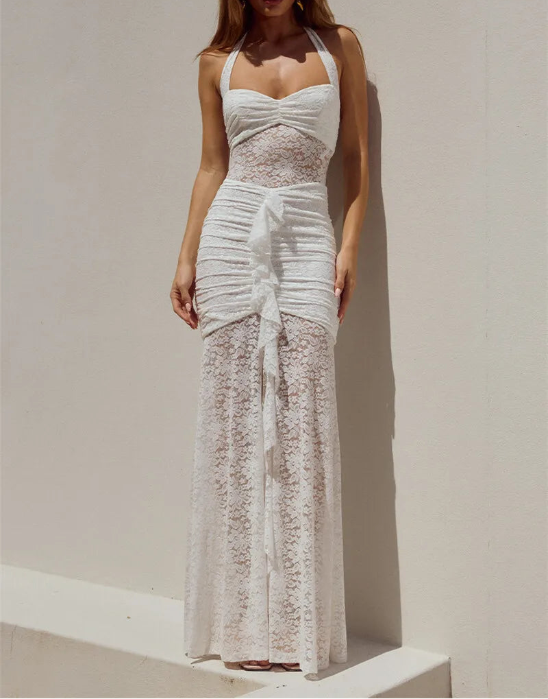 Woman wearing a white lace dress against a plain background