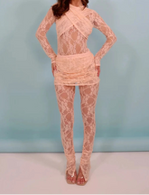 Woman wearing a pink lace outfit against a light blue background