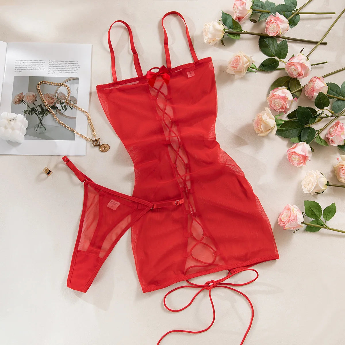 Red lingerie set with floral decorations on a light surface