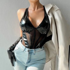 Mannequin wearing a black vinyl top, light blue jeans, and black gloves against a gray background.