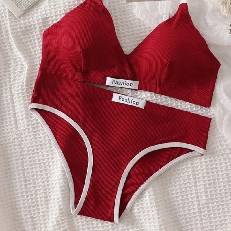 Red bikini set with 'Fashion' labels on a textured white surface