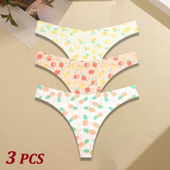 Three pairs of women's underwear with pineapple and fruit patterns on a beige surface.
