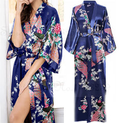 Navy blue satin robe with floral and peacock print on a white background