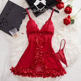Red lace lingerie set on a white fur surface with decorative items.