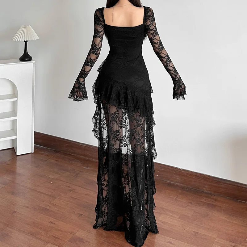 Black lace dress with long sleeves on a wooden floor.